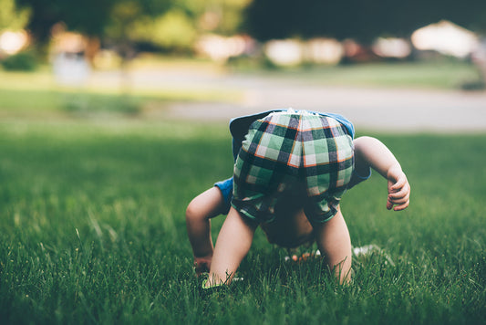 Toddler bending over, showing bottom