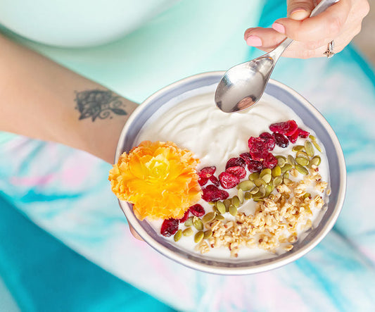 A woman holding a smoothie bowl